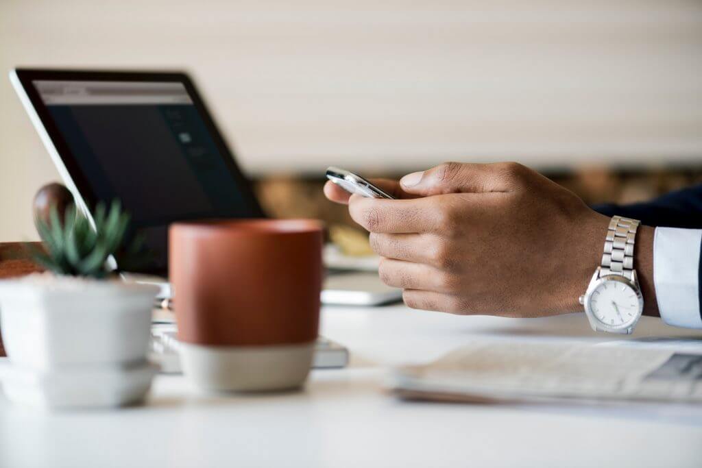 Zen Trader at Desk Checking Phone